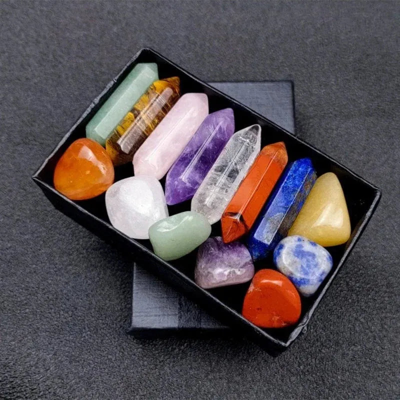 Assorted crystal points in a black box on a dark gray background