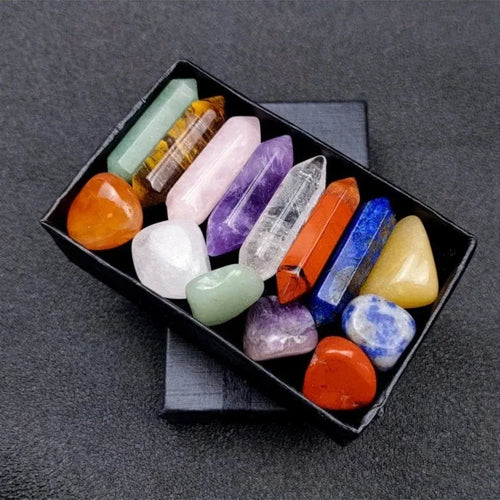 Assorted crystal points in a black box on a dark gray background