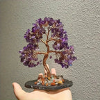 Amethyst crystal money tree feng shui decor purple gemstone tree held in hand view in light