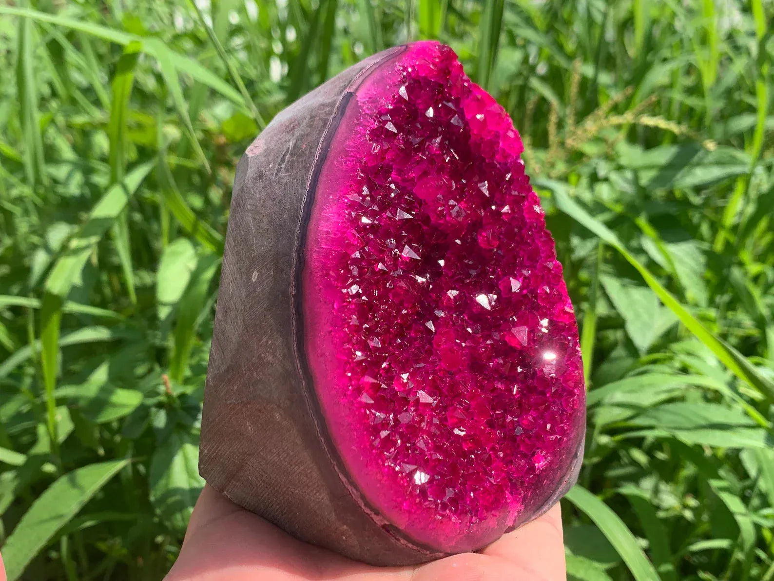 Pink druzy quartz geode crystal cluster side view showing natural sparkling surface