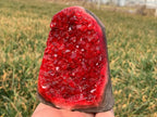 red quartz geode druzy crystal cluster angled view in hand outdoor
