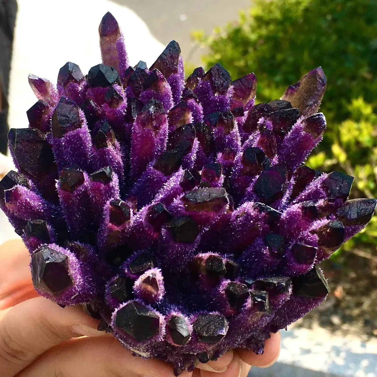 Raw violet stone cluster showing ghost crystal spikes